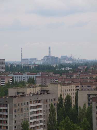 The Chernobyl power plant can be seen in the distance. Photo taken from the roof of a Pripyat apartment building. Photo by Juhana & Maria Pettersson.